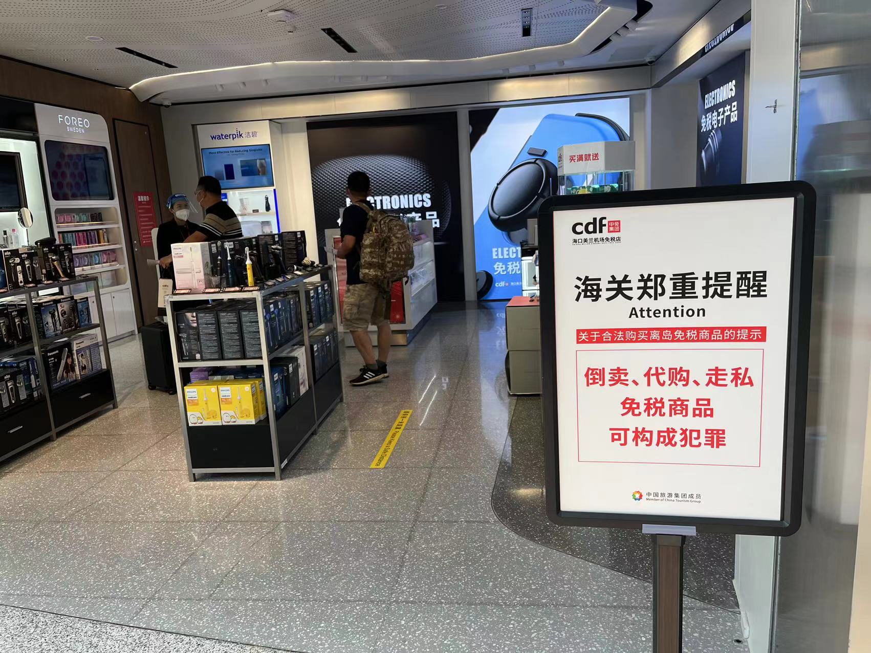 美兰国际机场免税柜台提示标语,时代财经/摄